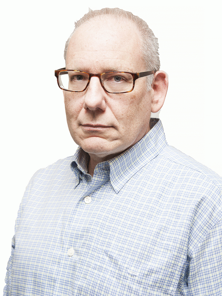 A headshot of David Leavitt with a slight smile. He is wearing a dress shirt and glasses.