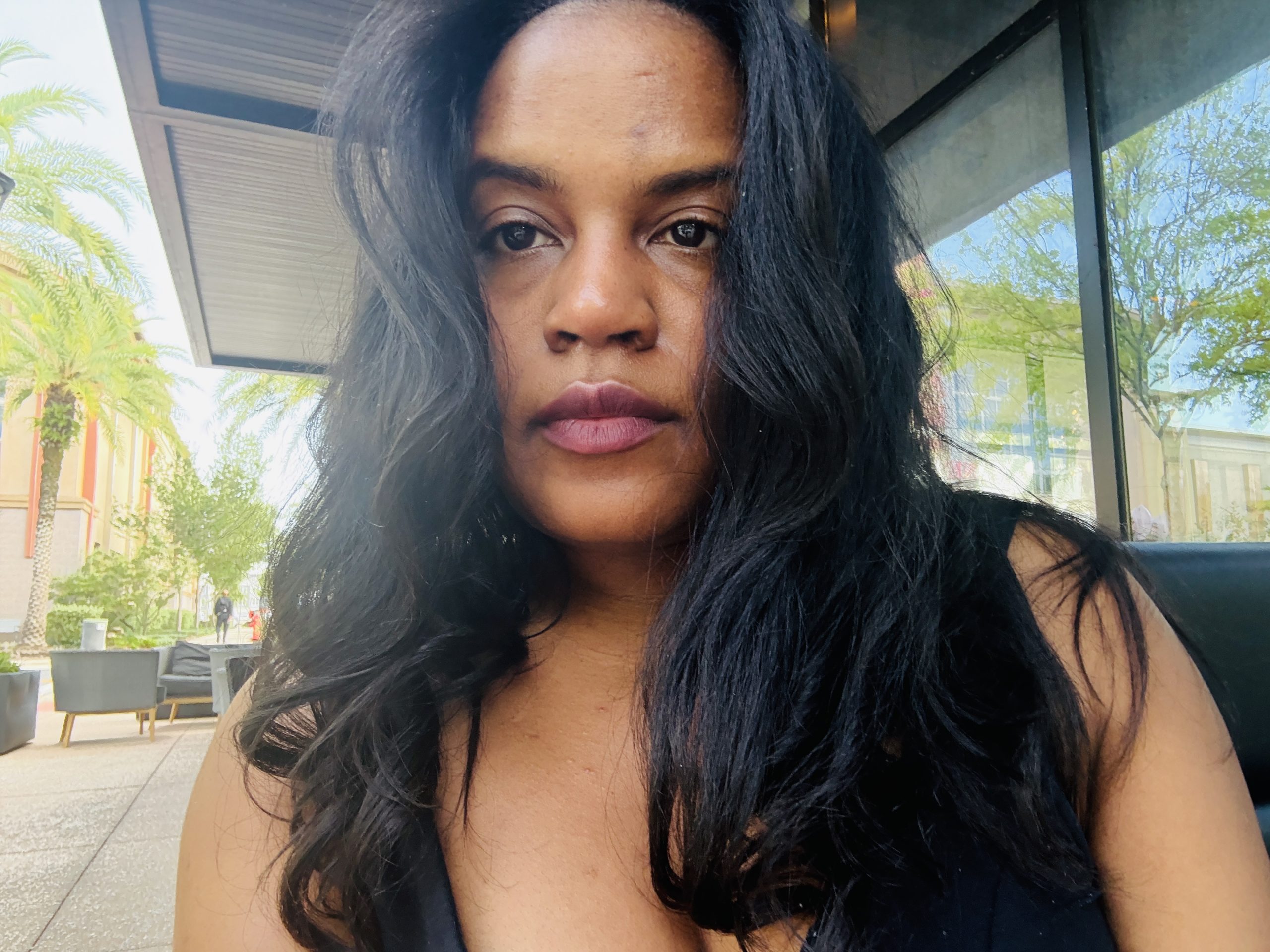 Catherine Saunders, a Black woman with long Black hair, is pictured outdoors. 