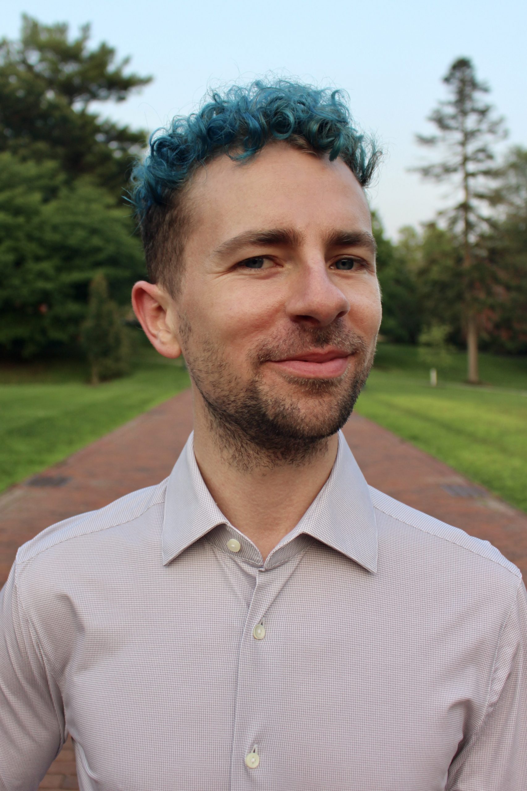 Tommy, with the blue hair, looks at a camera